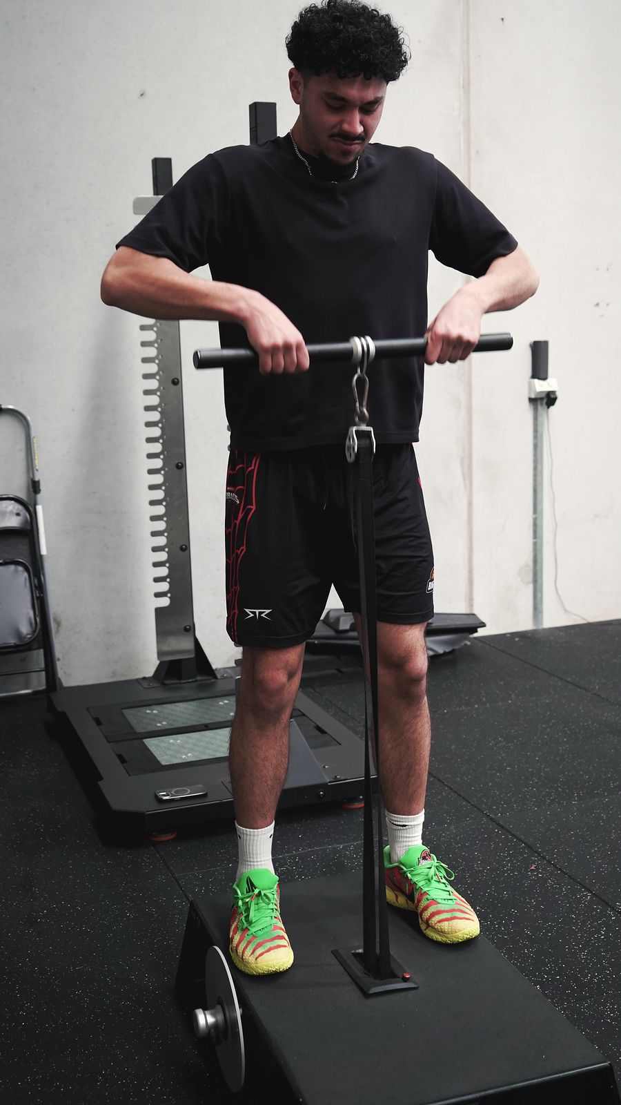 Athlete performing an isometric pull test on a force plate