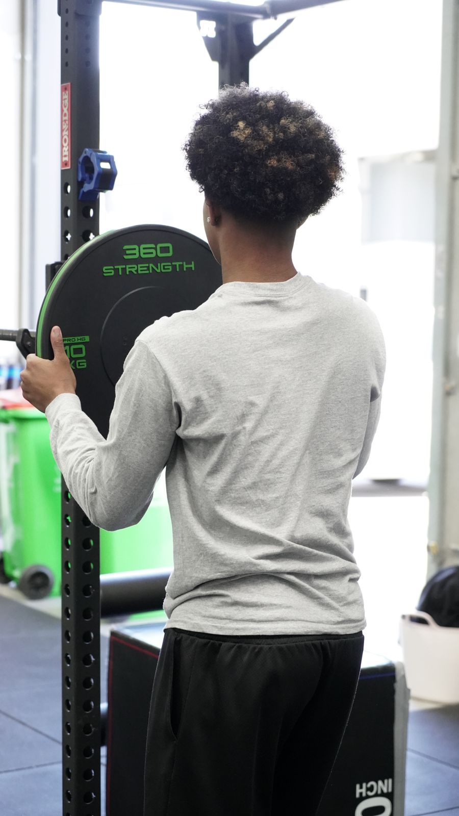 Junior player loading a weight plate in the From Zero gym