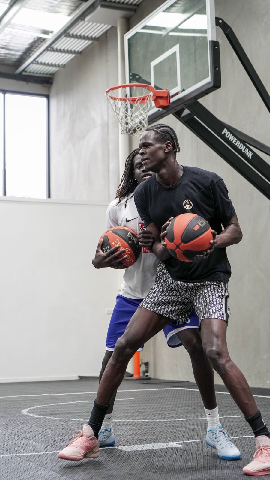 Two-ball handling drill under pressure from a defender